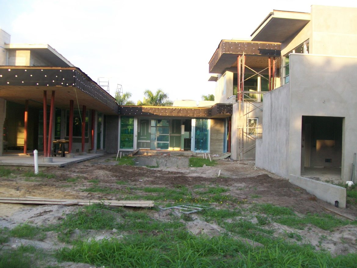 Modern house under construction with scaffolding.