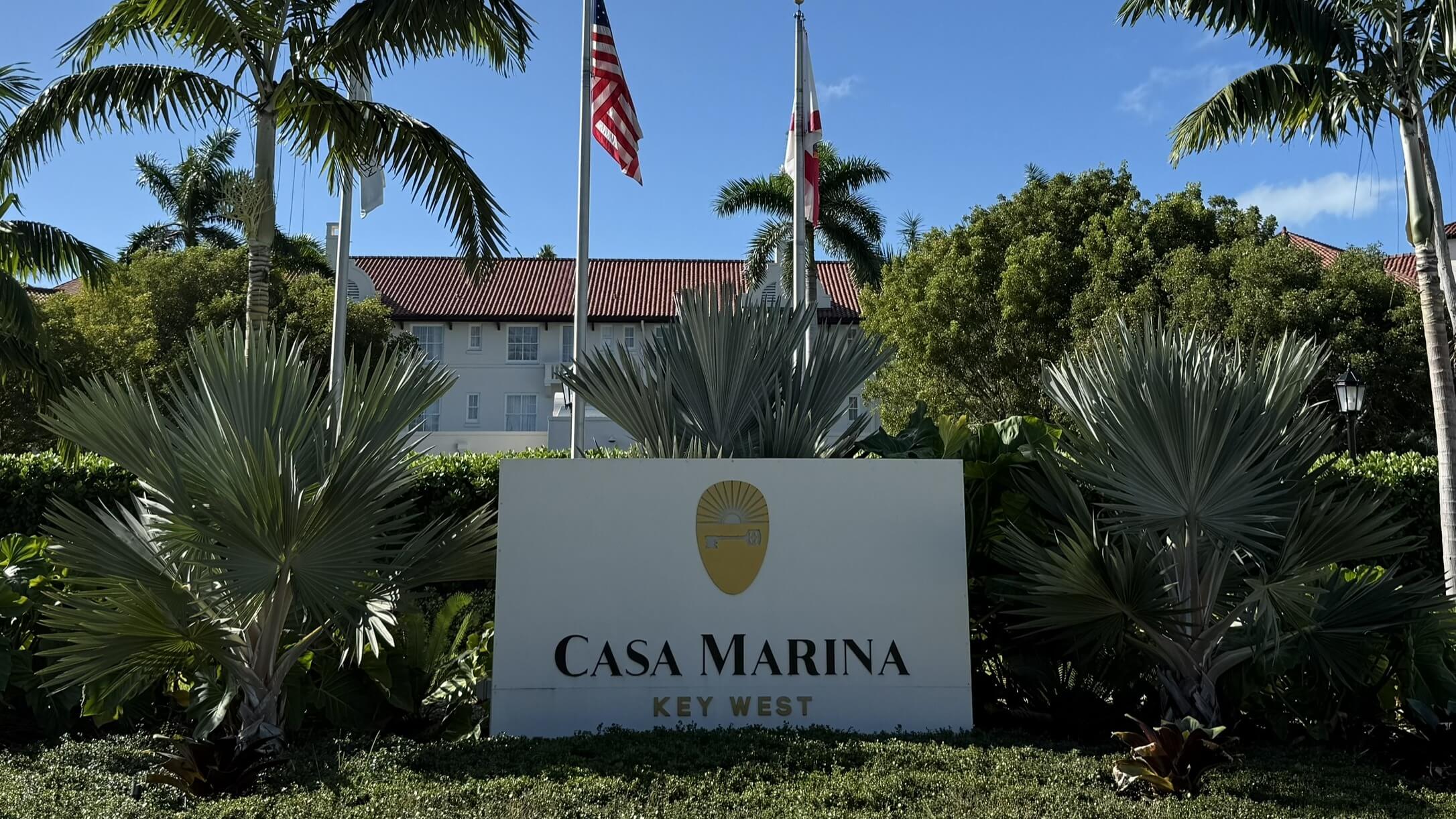 Casa Marina entrance sign with palm trees.