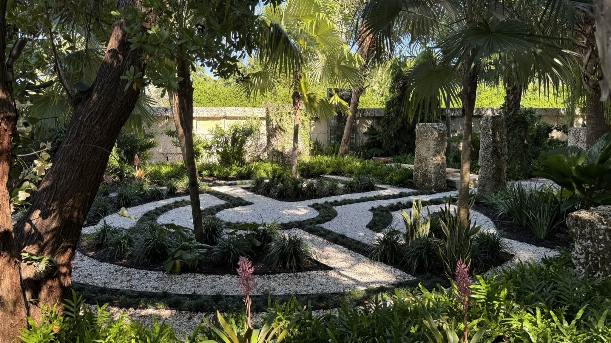 Lush garden with winding stone pathways.