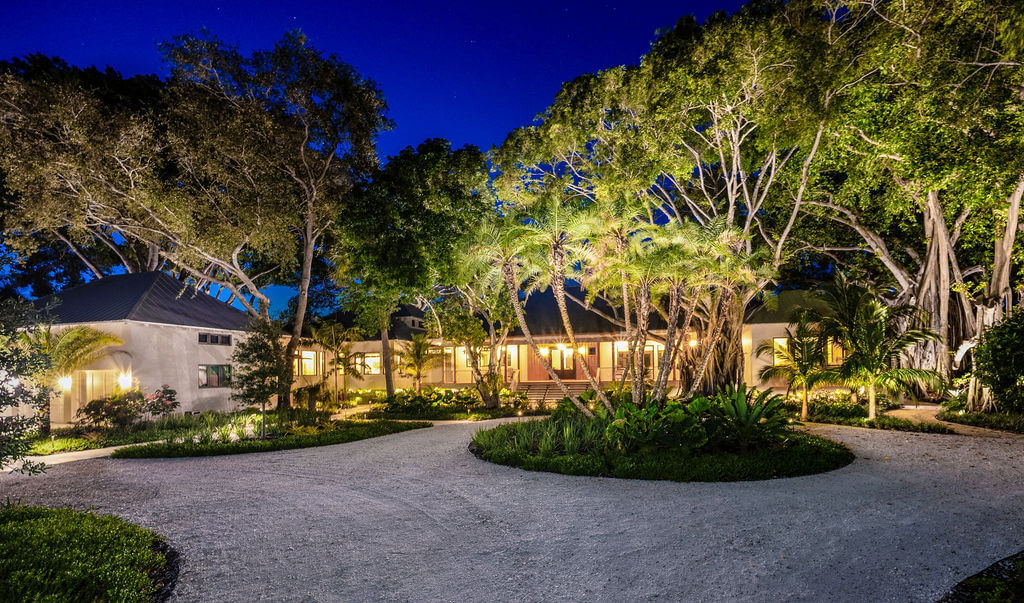 House surrounded by trees at night.