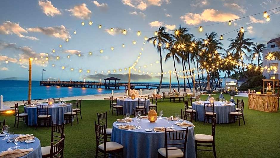 Oceanfront event setup with string lights.