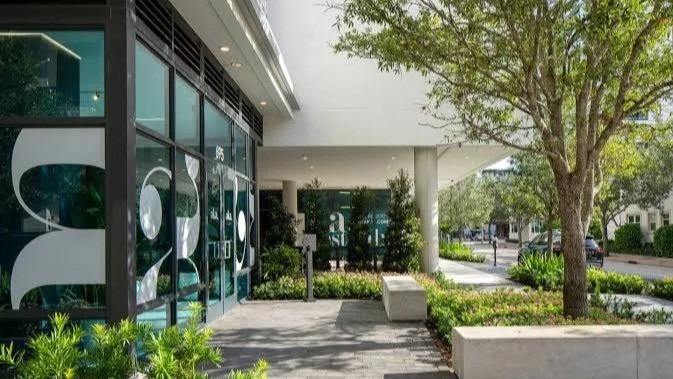 Modern building entrance with glass facade.