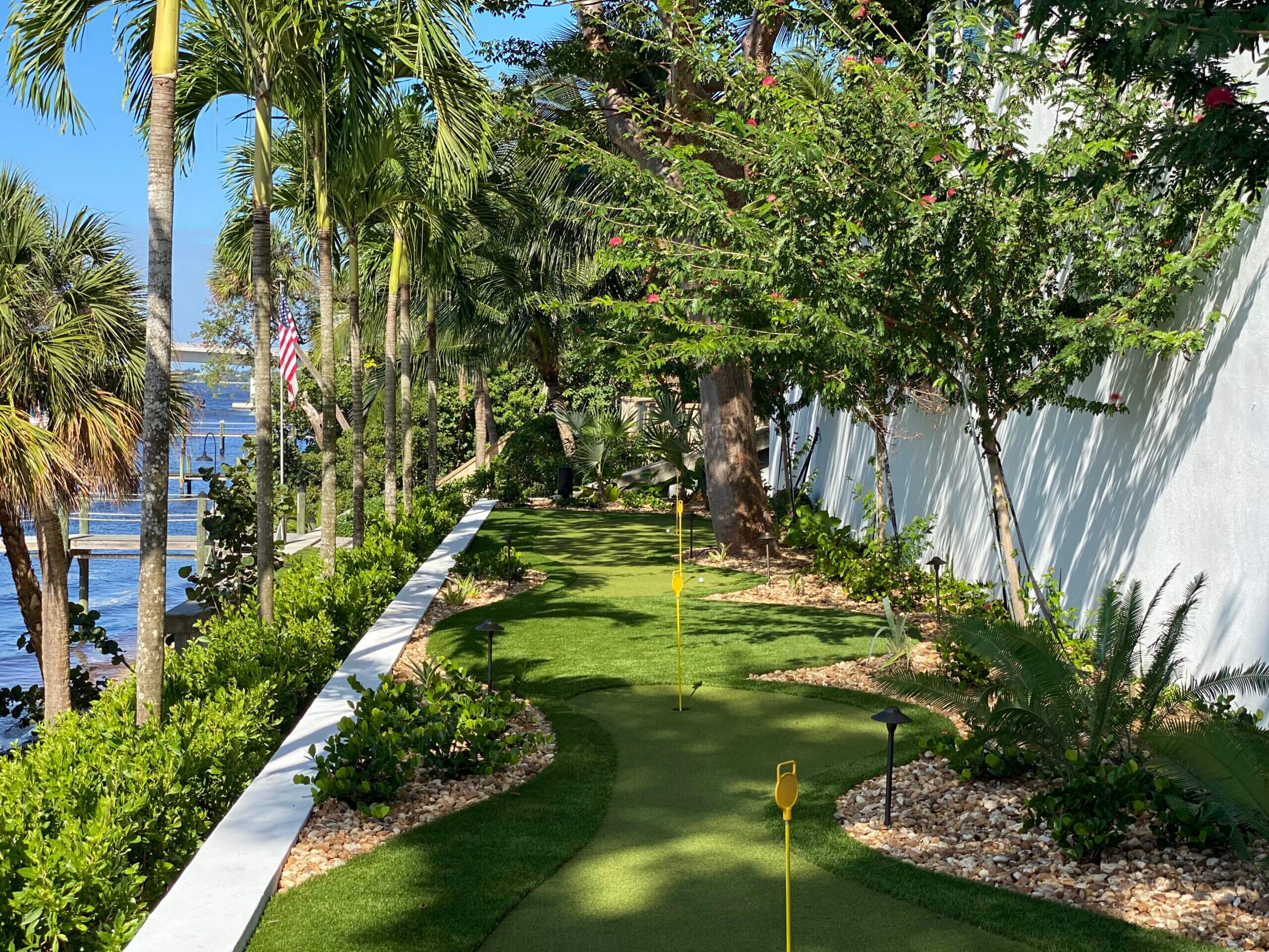 Mini-golf course surrounded by tropical plants.