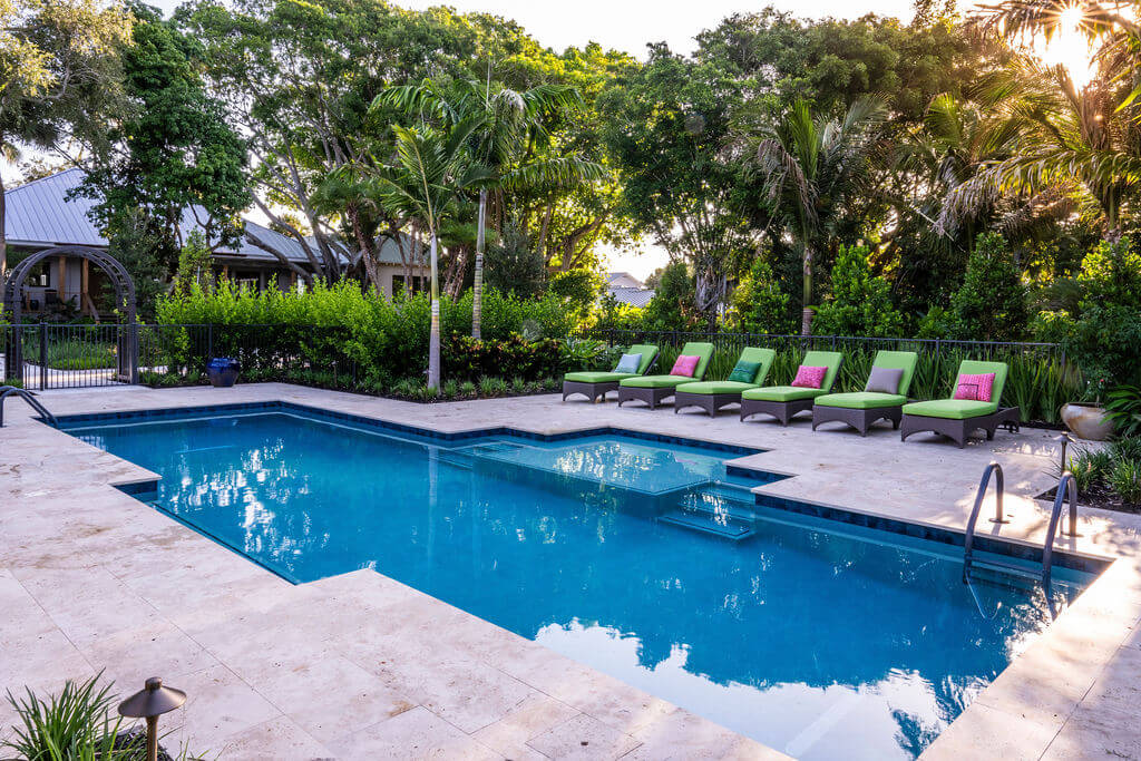 Modern backyard pool with lounge chairs.