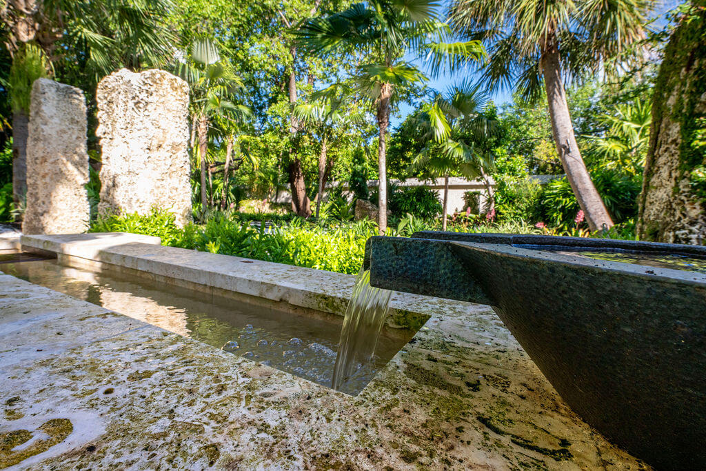 Water feature in lush tropical garden setting.