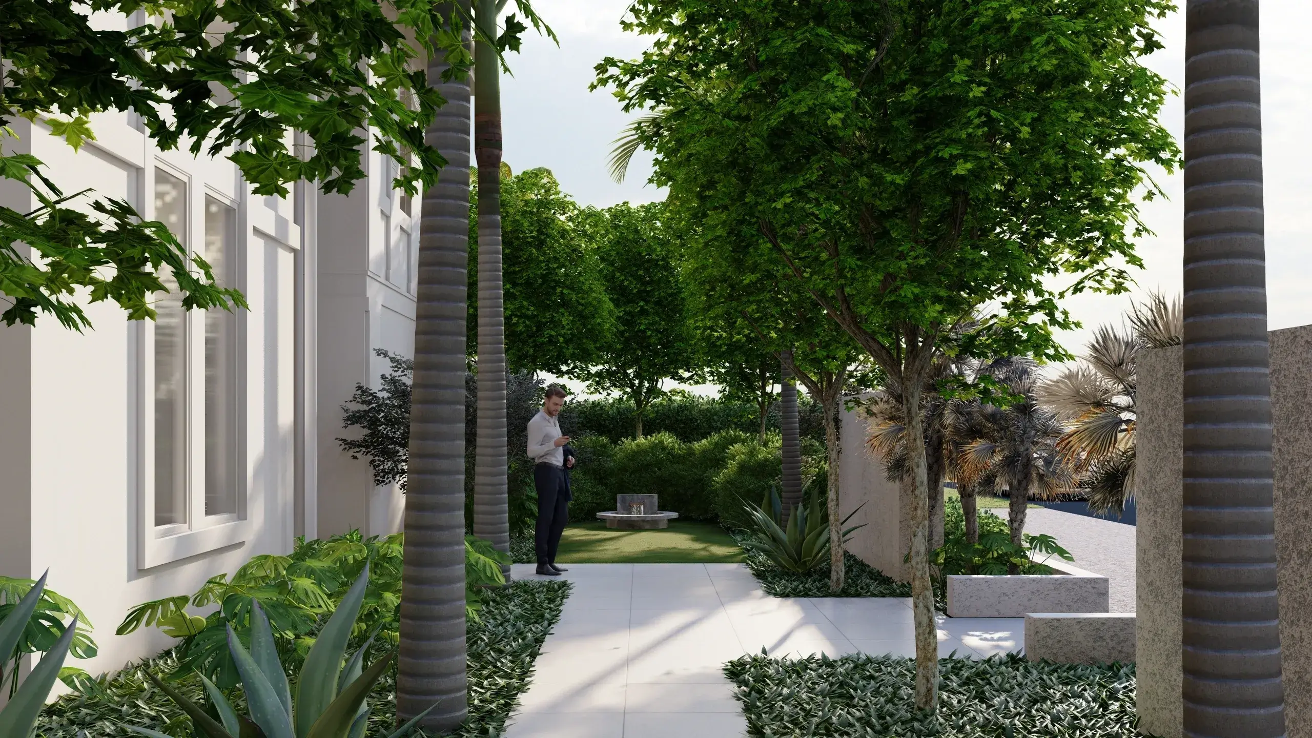 Man standing in a lush garden path.